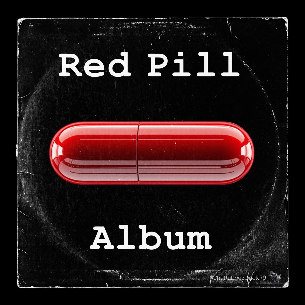 Cover of The Red Pill Album: a glossy red capsule pill on a scratched black sleeve, with “Red Pill” lettered at the top, “Album” at the bottom and The Rubber Duck™ in the lower right corner.