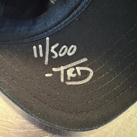 The brim of a signed hat, marked 11/500 TRD